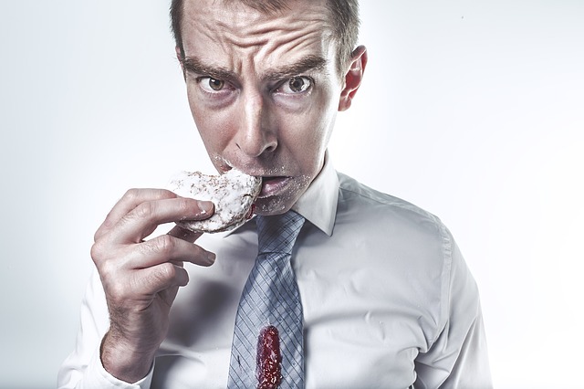 man dropping food in shirt